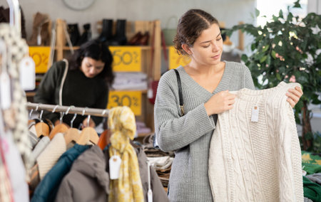 European woman chooses jersey sweater in store