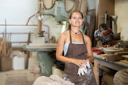 Young woman posing in workshopの写真素材