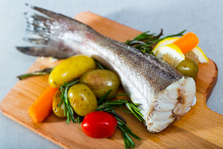 Tail of hake by rustically frying and served with boiled potatoes and tomatoesの写真素材