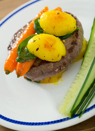 Beef patty with baked vegetables