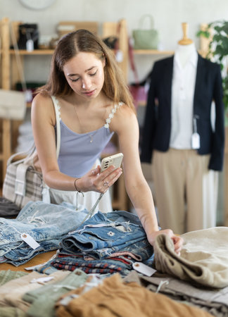 Attentive woman checking the quality of jeans or shortsの写真素材