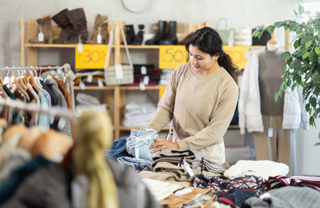 Latina woman choosing jeans in the storeの写真素材
