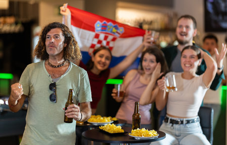 Group of fans in bar with Croatian flagの写真素材