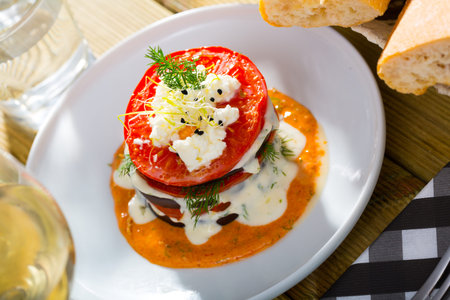 Grilled eggplant and tomatoes stack with spicy sauce