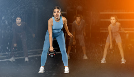 Young woman doing kettlebell thrusts in Crossfit trainingの写真素材