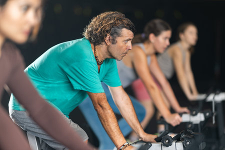 man doing exercises on a bicycle simulator during a crossfit workout