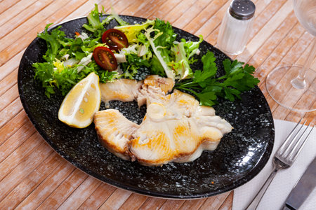 Dish of ocean fish tintorera (Prionace glauca) with lemon and herbs.の写真素材