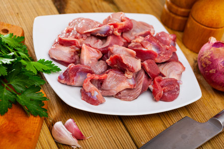 Raw chicken gizzards with greens and spices