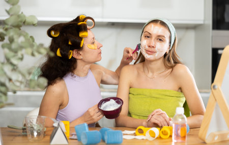 Applying mask to womans face with brush