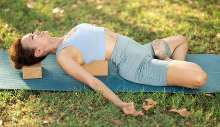 Adult woman doing yoga with blocks