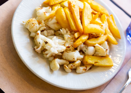 Picture of grilled tasty cuttlefish served with french fries