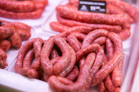 Sausages made of pork and chicken minced meat ready for grilling in meat shopの写真素材