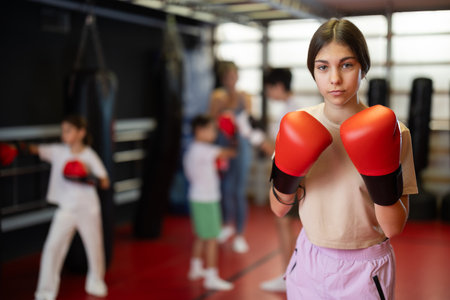 Girl posing during training in boxing glovesの写真素材