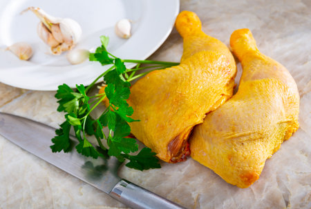 Two raw chicken thighs, parsley, garlic - there is set for cooking heartyの写真素材
