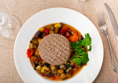 Meat patty with vegetables on a plate