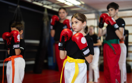 Group of children and teenagers train with boxing glovesの写真素材