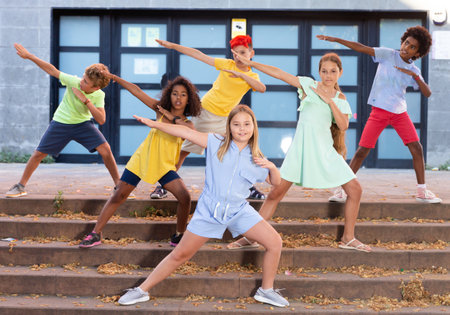 Modern cheerful tweenagers performing street dance choreographyの写真素材