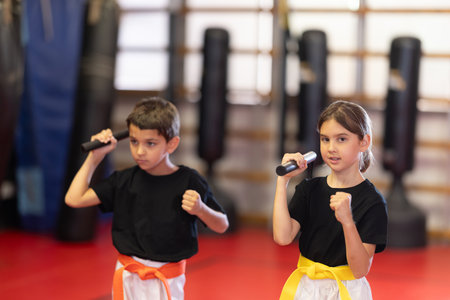Preparatory stage of training, teen children are doing strength exercises in gymの写真素材