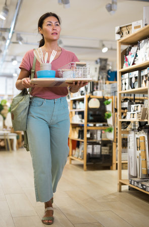 Woman standing at household goods storeの写真素材