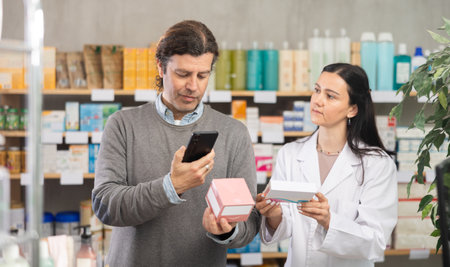 man scans a package with pills in a pharmacy on a mobile barcodeの写真素材