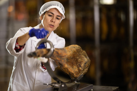 woman put the jamon on the bod and is preparing to cut