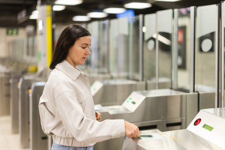 Woman passes through metro turnstile, paying with card