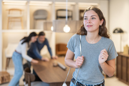 Woman buyer chooses furniture in furniture storeの写真素材