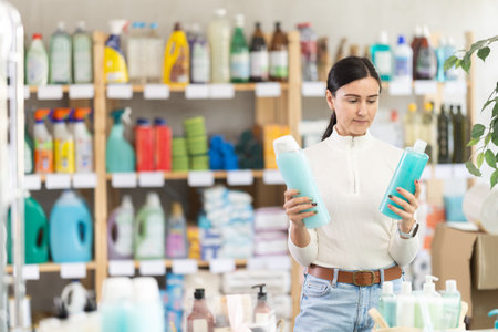 European woman chooses shampoo and shower gelの写真素材