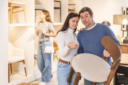 Adult couple choosing a chairの写真素材
