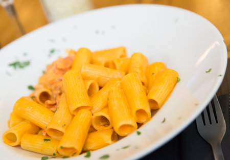 Rigatoni pasta with bacon, tomato and creamの写真素材