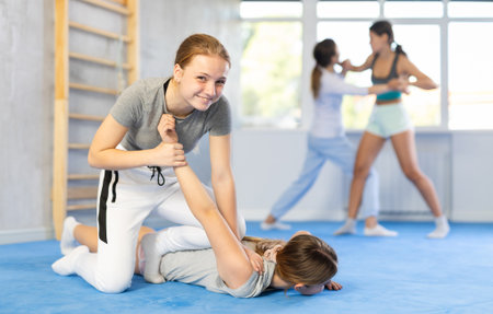 Two teenage girls training in group self defense classesの写真素材