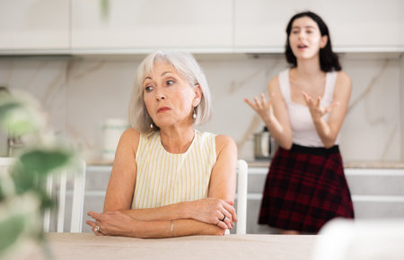 Offended senior woman listening her daughterの写真素材