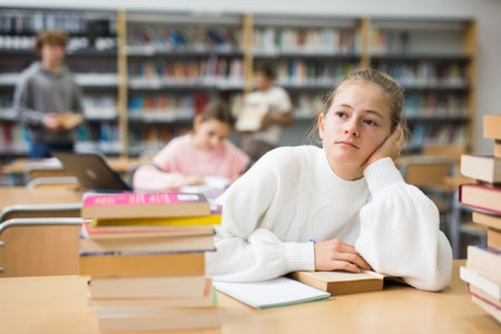 Fourteen-year-old schoolgirl writes out an synopsisの写真素材