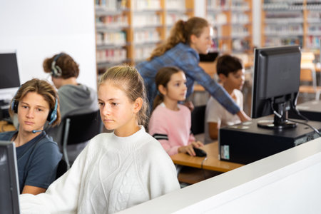 Schoolchildren preparing for lessons on the computerの写真素材