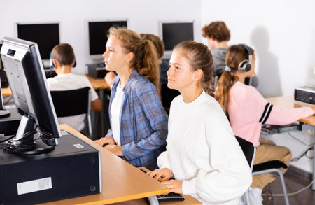 Teenager girls and boys studying in computer labの写真素材