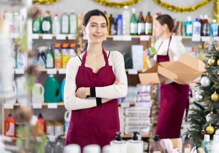 Woman seller with assistant in household chemicals storeの写真素材