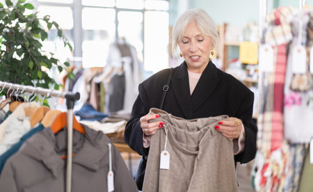 Regular customer senior woman chooses color and style of trousersの写真素材