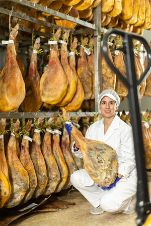 Adult female specialist working in a jamon factoryの写真素材