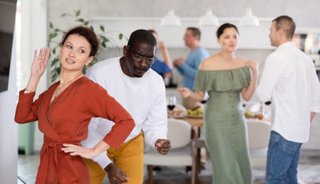 Joyous lively woman dancing at friendly house partyの写真素材