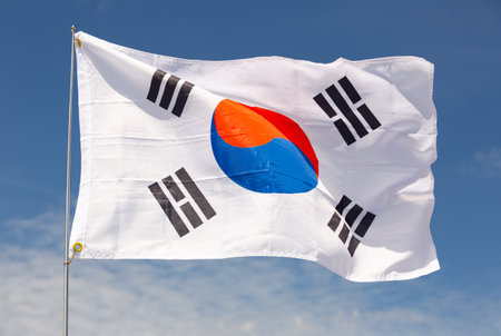 South Korea flag is waving against blue skyの写真素材