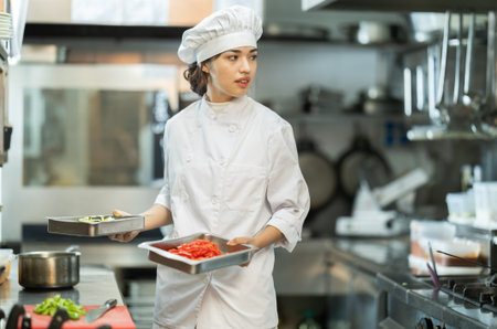 Young woman cooker work at kitchenの写真素材