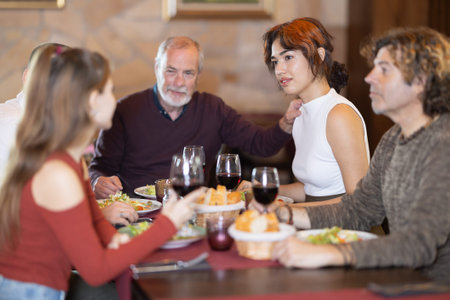 Family members enjoying warm conversation in restaurant