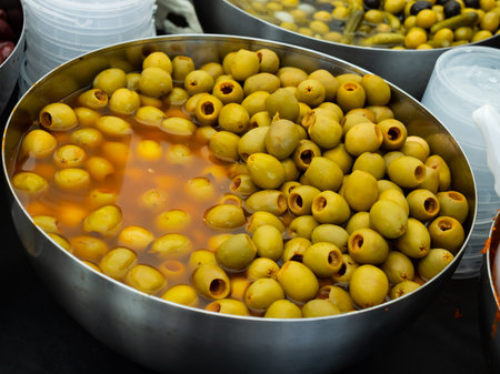 Pile of pitted green olives in bucketの写真素材