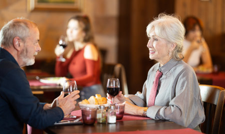 Mature couple communicate and chatting during date in cafeの写真素材