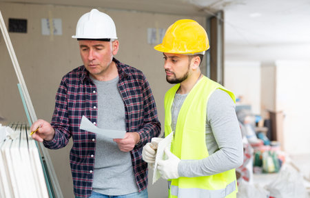 Foreman and builder counting construction materials
