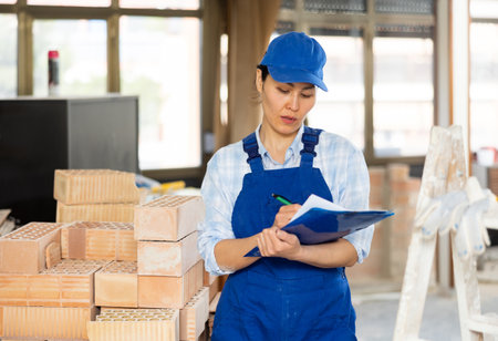 Portrait of an asian builder woman who checks completed work onの写真素材