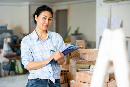 Asian woman makes important notes on paperの写真素材