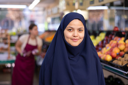 Portrait of young woman shopper in hijab in supermarketの写真素材