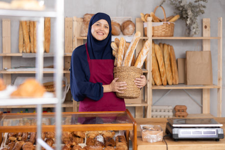 Muslim seller holding bread in shopの写真素材