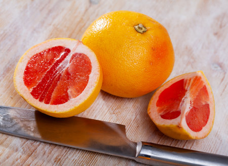 Sliced grapefruit on wooden tableの写真素材